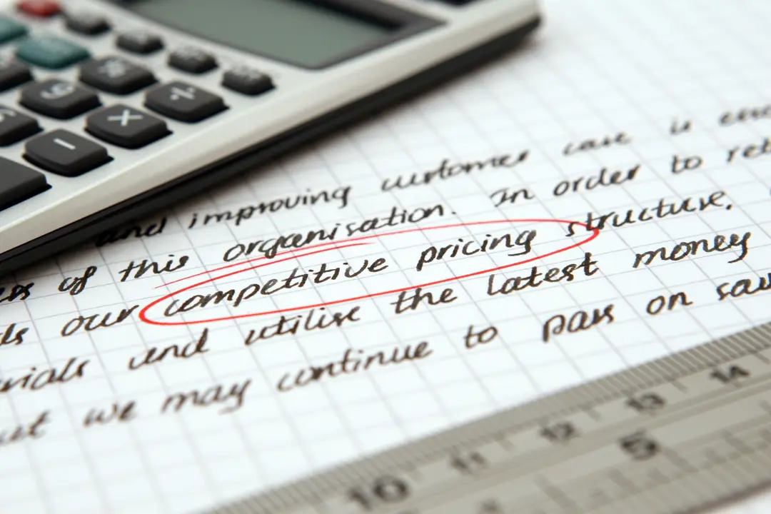 Calculator and paperwork used to evaluate a property asking price
